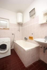 ein Badezimmer mit einer Waschmaschine und einem Waschbecken in der Unterkunft Apartments by the sea Savar, Dugi otok - 8080 in Brbinj