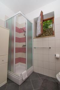 a bathroom with a shower with a glass door at Apartments by the sea Mali Losinj (Losinj) - 8093 in Mali Lošinj