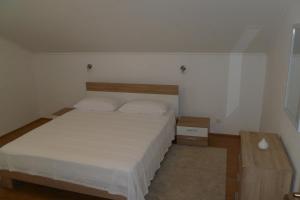 a small bedroom with a bed and a table at Apartments with a parking space Sali, Dugi otok - 8154 in Sali