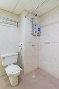 a bathroom with a toilet and a shower at HIG Homestay Apartment in Kuah