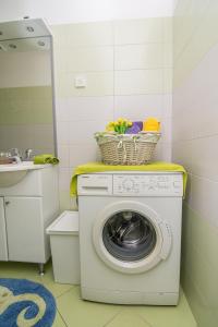 a washing machine in a bathroom with a sink at Apartment Mali Losinj 8093b in Mali Lošinj