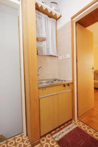 a small kitchen with a sink and a sink at Family friendly apartments with a swimming pool Okrug Donji, Ciovo - 8072 in Okrug Donji
