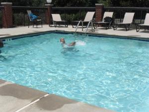 a person is swimming in a swimming pool at Holiday Inn Express & Suites Reidsville, an IHG Hotel in Reidsville