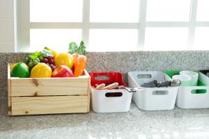 a wooden crate of fruits and vegetables on a counter at Landara Private Pool Villa Sattahip in Sattahip
