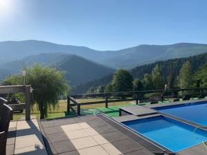 a swimming pool with a view of the mountains at Romanka in Żabnica