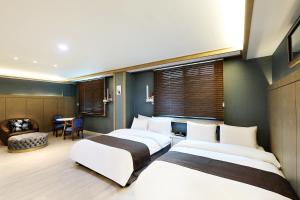 Postel nebo postele na pokoji v ubytování Buan Tourist Hotel
