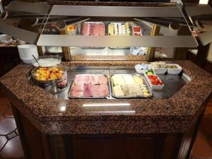 a kitchen counter with many food items on it at Historik Hotel Ochsen in Tamm