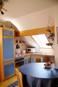 a kitchen with a blue table in a kitchen at Beim Rieder in Truchtlaching