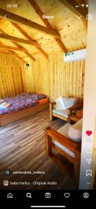 a bedroom with two beds in a wooden cabin at Hellena in Sarajevo