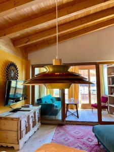 a large chandelier hanging in a living room at Apartments DA LA VEDLA Flats in San Cassiano