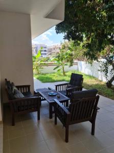 a patio with benches and a table and chairs at Rhodes Comfort Luxury Apartment in Rhodes Town