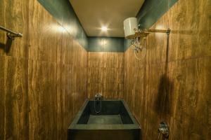 a bathroom with a sink in a wooden wall at The Bheemgarh in Jaisalmer