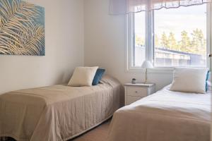 Postel nebo postele na pokoji v ubytování Tuomenkartano Apartments by Hiekka Booking