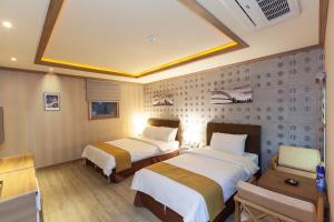 Ένα ή περισσότερα κρεβάτια σε δωμάτιο στο Sahara Hotel