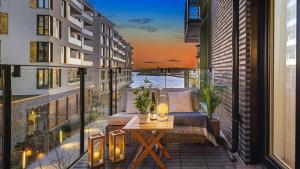 a balcony with a chair and a table on a building at Exclusive apartment, sea view to Oslo fjord, located on water in Oslo center in Oslo