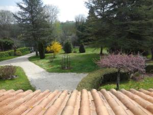a view of a garden from behind a brick wall at La Madriguera Accommodation in Gardes-le-Pontaroux +7 photos