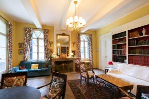 a living room with a couch and a fireplace at Château de Saü in Thuir