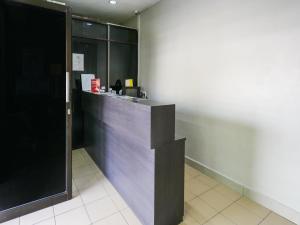 a lobby with a counter in a building at OYO 89950 365 Nice Stay in Miri
