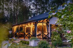 a house with a porch with lights on it at White & Black in Kołczewo
