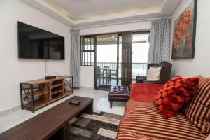 a living room with a couch and a tv at 8 Bronze Beach Umhlanga Rocks in Durban