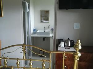 a bathroom with a sink and a stair railing at Cape Dawn Guest House in Parow