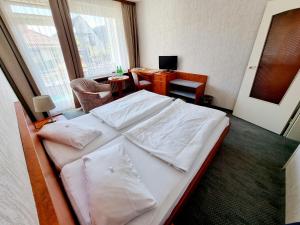 Postel nebo postele na pokoji v ubytování Hotel Heikenberg