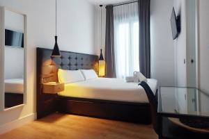 a hotel room with a bed and a window at Woohoo Rooms Chueca in Madrid