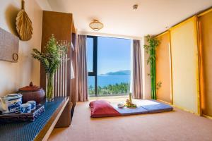 a living room with a large window with a view at DTX Hotel Nha Trang in Nha Trang