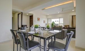 a dining room with a table and chairs at Treebo Trend Excellent Homes, Nashik in Nashik