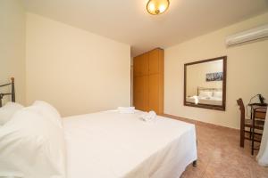 A bed or beds in a room at Afroditi Holiday Home - Yellow Apartment