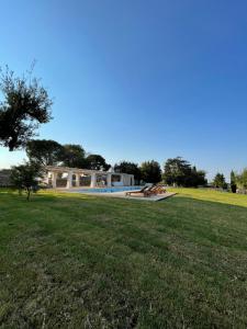 a house with a swimming pool in a grass field at Masseria Santella in Cassano delle Murge