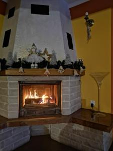 a fireplace in a living room with a fire at Apartament Fort Owcza Góra in Kłodzko