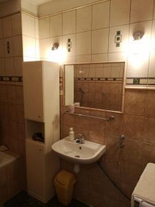 a bathroom with a sink and a toilet and a mirror at Apartament Fort Owcza Góra in Kłodzko