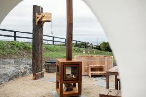 a woodburning stove and a bath tub in a yard at Gate Lodge@White Strand in Miltown Malbay