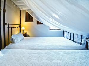 a bedroom with a bed with a canopy at Eveleos Country House in Tochni