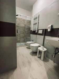 a bathroom with two sinks and a toilet and a shower at San Siro 139 in Milan