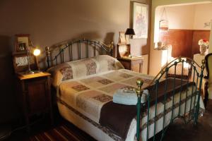 a bedroom with a bed and two night stands at Lentelus Guesthouse in George