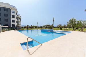 a swimming pool in the middle of a building at Perla Oliva Nova in Oliva