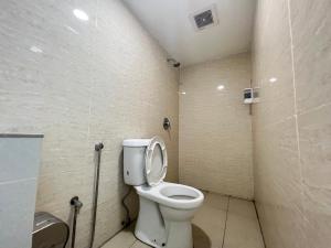 a bathroom with a toilet in a room at OYO 90789 Stutong Point in Kuching