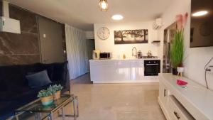a living room and kitchen with a couch and a table at נגיעות הגולן in Moshav Ramot