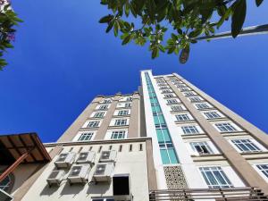 a tall building with a blue sky in the background at Apartment Homestay SA in Kota Bharu