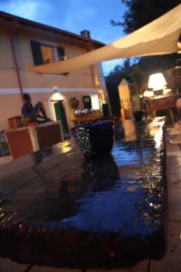 a person sitting on a bench in the rain at BBQ Lodge in Camogli