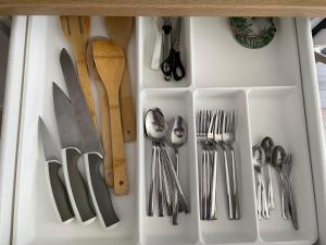 a drawer filled with silver utensils on a counter at Nice to stay in Visaginas