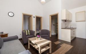 a living room with a couch and a table and a kitchen at Holiday apartment Boko in Pinezici