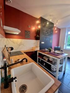 a kitchen with a sink and a counter top at La Trappiste in Liévin