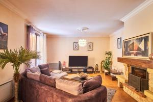 a living room with a couch and a fireplace at Villa De Marchi in Saint-Just-de-Claix