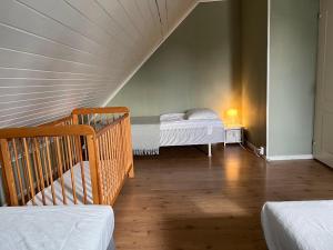 a room with two beds and a staircase in a house at Big house, sauna, Wi-Fi, Isaberg, MTB, skiing, golf in Gnosjö