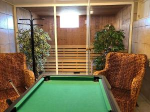 a room with a pool table and two chairs at Big house, sauna, Wi-Fi, Isaberg, MTB, skiing, golf in Gnosjö