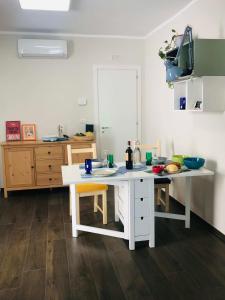a kitchen with a white counter in a room at Donna Flor casa vacanze in Barletta