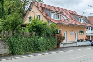a house with a fence next to a street at Appartement-Amber in Überlingen
